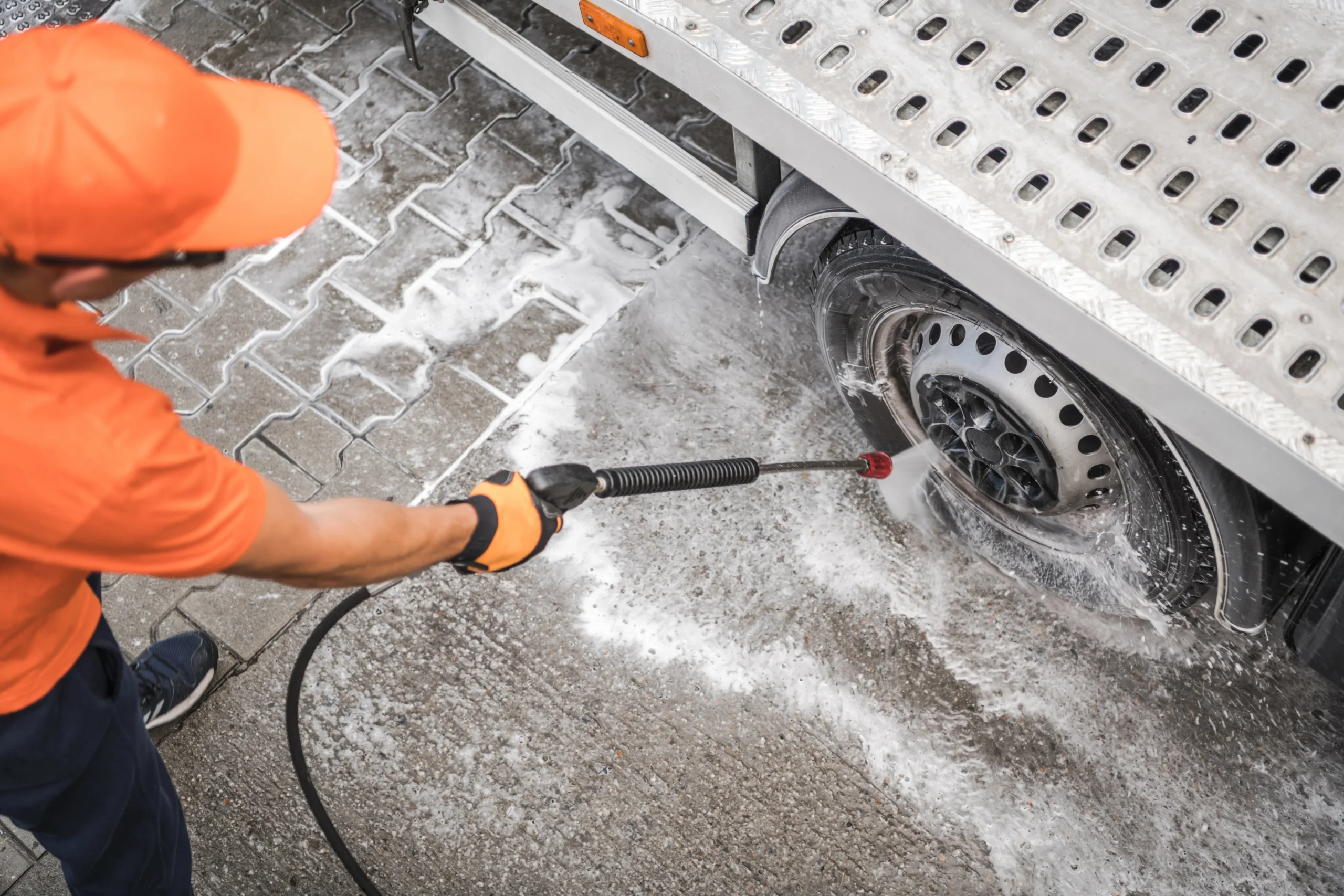 person-cleaning-a-truck-wheel-with-a-pressure-wash-2026-03-25-07-42-14-utc